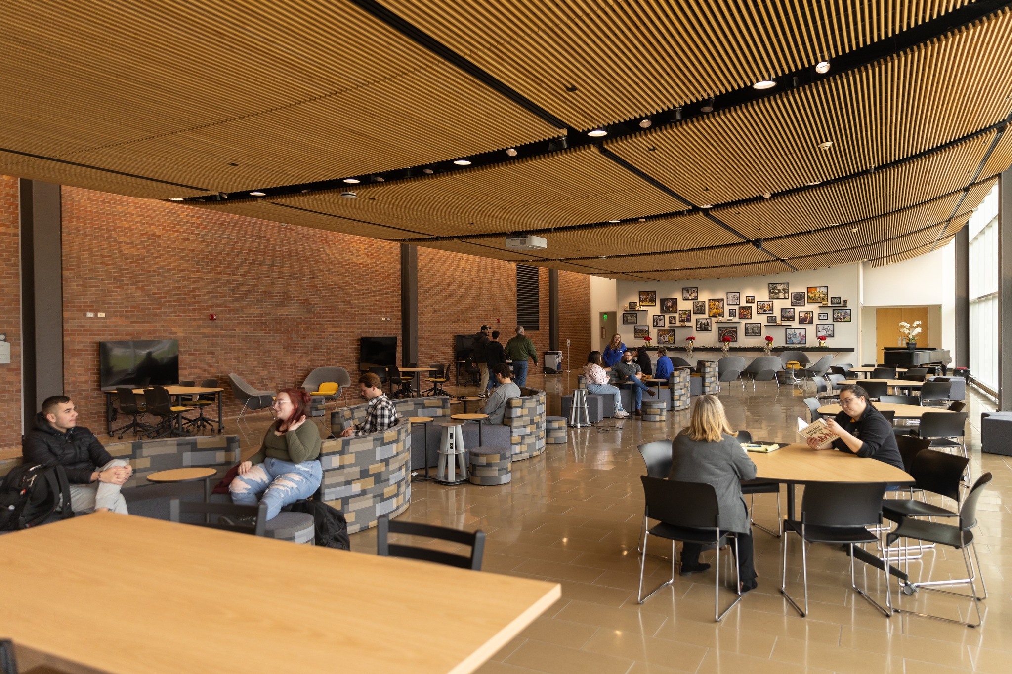 University library community room open space with tables and students studying